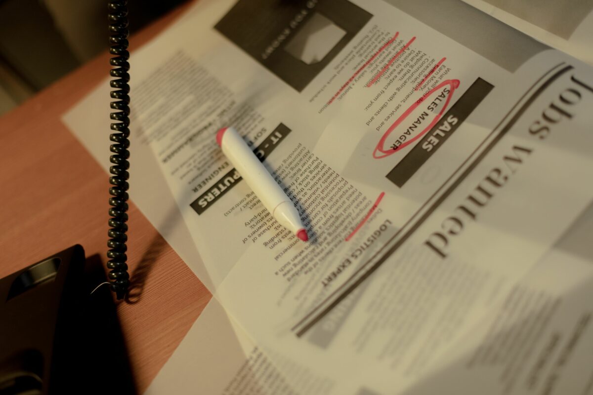Page d'offres d'emploi d'un journal avec un marqueur rouge